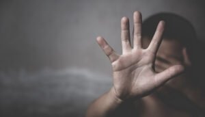 a person showing shame while covering face