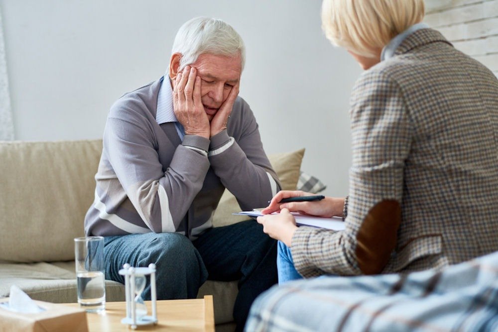 Senior man in counseling session exploring is kratom an opioid concern.